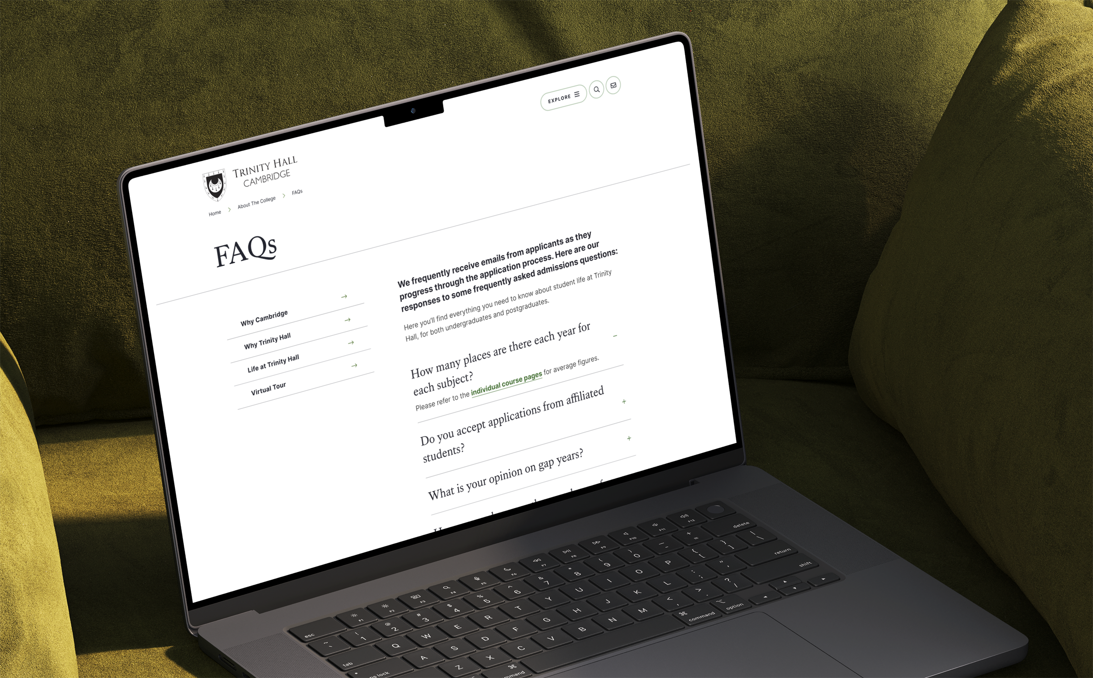 The FAQs section of the Trinity Hall College website mocked up on a laptop
